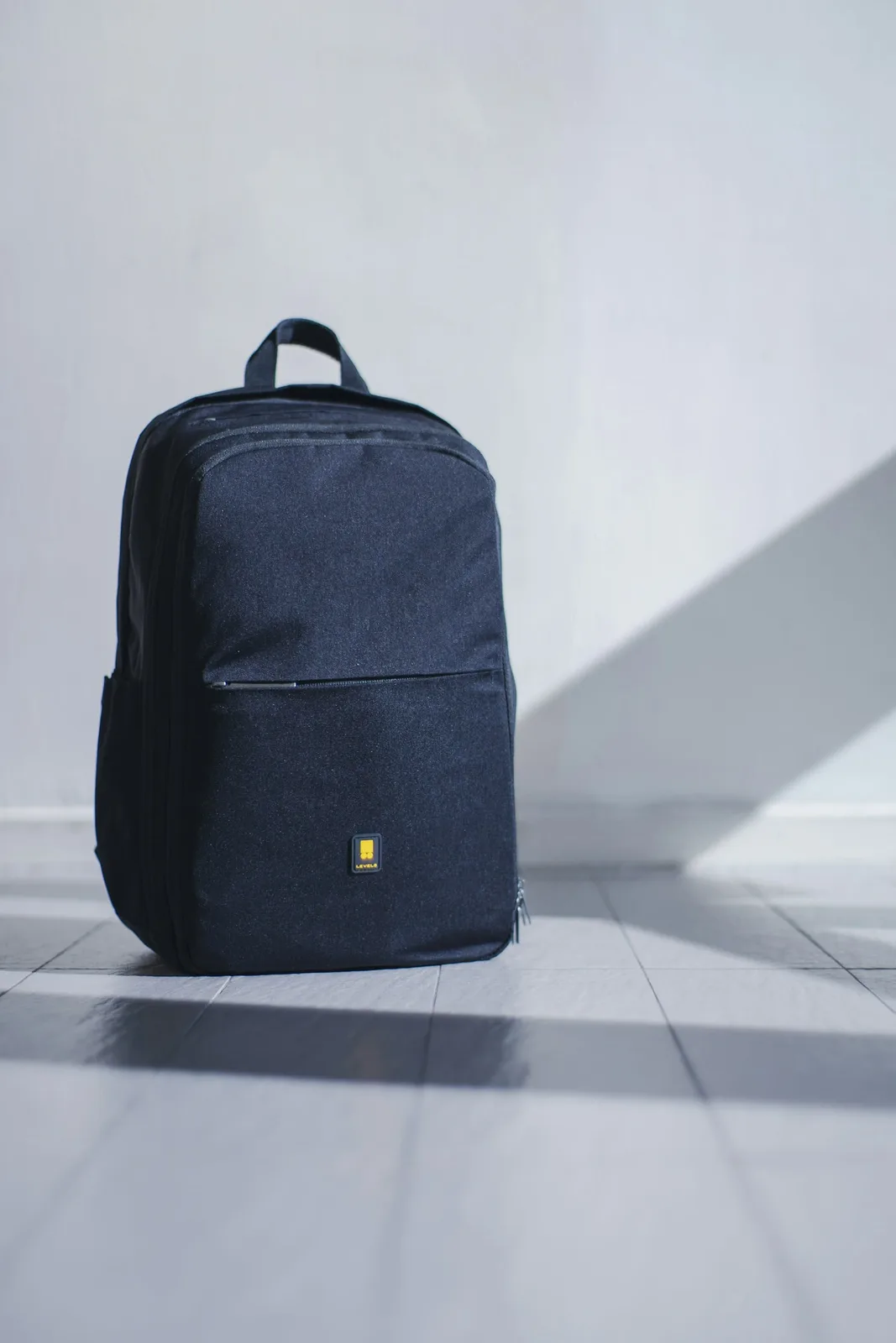 Backpack, camera and maps on a table
